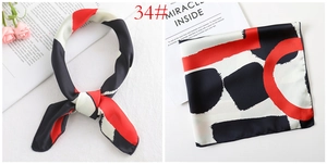 Detail of silk satin square scarf with red and black geometric color block patterns