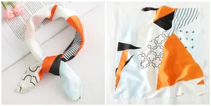 Detail of a 50x50cm square silk scarf with geometric color blocks and floral prints