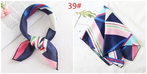 Macro detail of geometric striped silk scarf showing texture and vibrant colors
