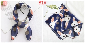 Detailed view of 100% silk navy square scarf with grey polka dots and rabbit print