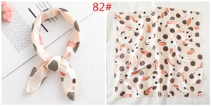 Detail of pink silk-like square scarf featuring cute rabbit patterns and polka dots