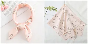 Detail of light pink silk scarf featuring cartoon alpaca and feather print pattern
