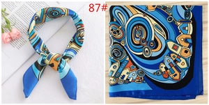 Detail of blue abstract print square silk scarf with geometric patterns and styling