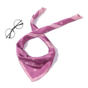 Detail of silk-like scarf featuring white camellia floral pattern and dual-tone purple color