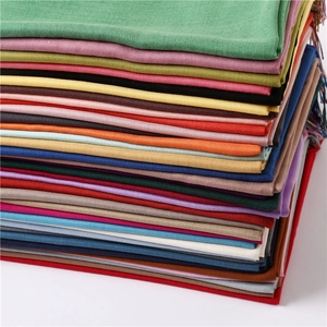Macro shot of colorful lightweight cashmere scarfs with fine fringe and woven textures