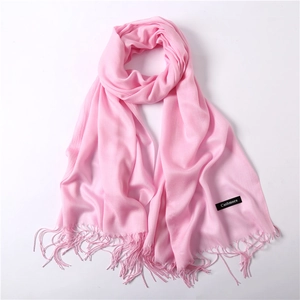 Close-up of pink cashmere scarf with fine tassels and a soft, lightweight texture