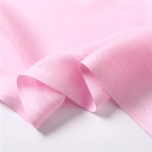Close-up of soft pink fabric texture with elegant draping and fine weave details