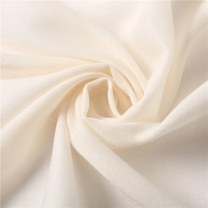 Close-up of pure white pashmina fabric showing fine plain weave texture and soft material