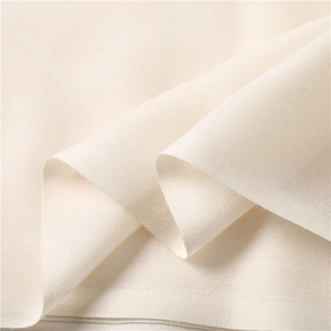 Macro detail of cream cashmere-style fabric showing the soft plain weave texture and edges