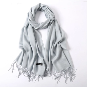 Detailed view of light blue cashmere shawl featuring soft fringed edges and fine texture