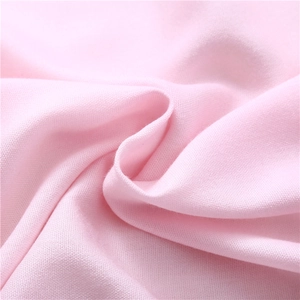 Close-up of soft light pink cashmere-like fabric with fine texture and warm feel
