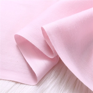 Close-up of soft pink pashmina scarf fabric showing fine knit texture and weaving detail
