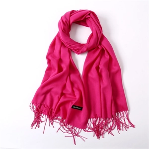 Solid bright pink cashmere-like shawl scarf with elegant fringe details on white background