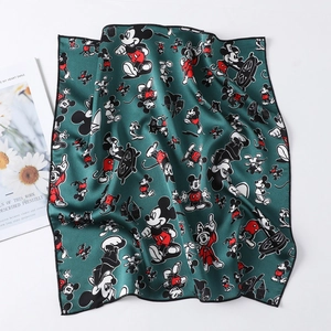 Detail of dark green silk square scarf with Mickey Mouse print and fine black rolled edges