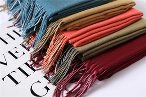 Macro detail of multicolored double-sided cashmere shawls with fringe and twill weave
