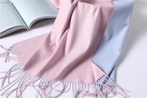 Detail of pink and light blue double-sided cashmere-like scarf with fringe tassel edge