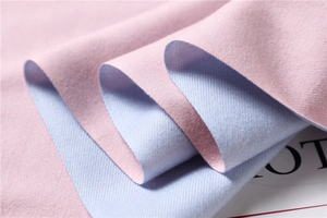 Detail showing the fine twill weave of a soft reversible pink and blue cashmere-like scarf