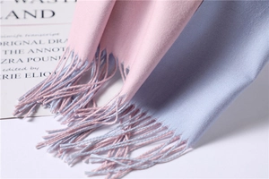 Detailed macro shot of pink and lilac cashmere-like scarf with fringe and twill weave