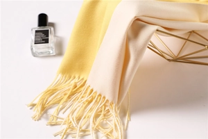 Close-up of yellow and white dual-tone scarf featuring soft texture and fine fringe details