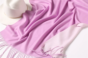 Detailed macro view of soft purple cashmere-feel scarf with elegant fringe texture