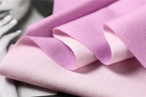 Detailed close-up of double-sided pink cashmere-style scarf with soft brushed texture