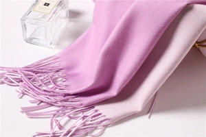 Close-up of soft purple and pink cashmere-like scarf showing delicate fringe and texture