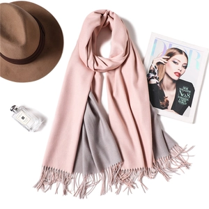 Detail of pink and grey cashmere-like scarf with fringe tassels and luxury accessories