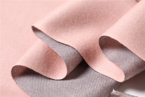 Detailed close-up of reversible cashmere-feel scarf in pink and grey showing twill texture