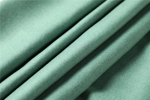 Detail of pea green twill fabric showing fine texture and soft drape of cashmere shawl