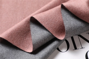 Macro shot of double-sided cashmere-style scarf in pink-brown and gray textured fabric