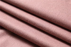 Close-up of soft dusty rose faux cashmere fabric texture with delicate fibers and soft folds
