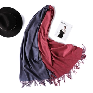 Detail of navy blue and burgundy reversible cashmere scarf with fine tassel edges