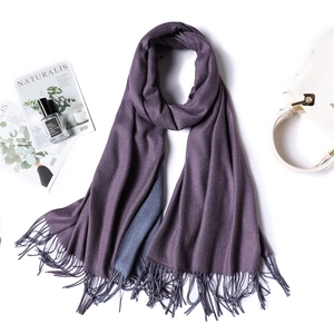Detail of soft double-sided cashmere scarf in deep purple and grey blue with fringe