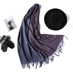 Detail of two-tone cashmere pashmina shawl with fringes and elegant fashion accessories