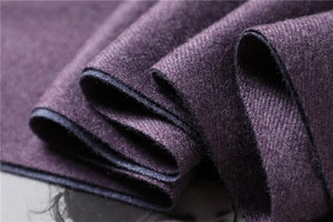 Detailed close-up of dark purple cashmere-style scarf showing soft twill weaving texture