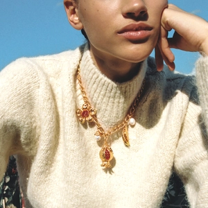 Vintage gold baroque necklace with pomegranate and floral pendants on a model