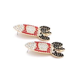 Detailed view of gold-tone rocket earrings with colorful rhinestones on white background