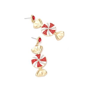 Detail of candy-shaped earring with red and white rhinestones on golden metal base