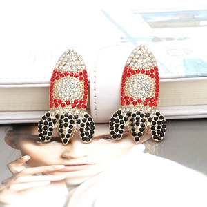 Chic gold rocket earrings encrusted with colorful rhinestones on a fashion magazine