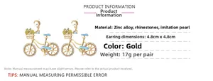 Detailed view of colorful bicycle drop earrings with rhinestones and faux pearls