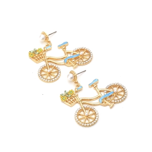 Cute bicycle earrings with blue enamel, rhinestones and pearls on white background