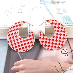 Exaggerated C-shaped gold hoop earrings with pink and red enamel checkerboard pattern