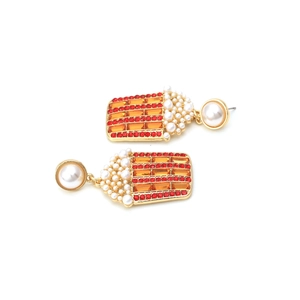 Macro detail of creative popcorn bucket earrings with red rhinestones and white pearls
