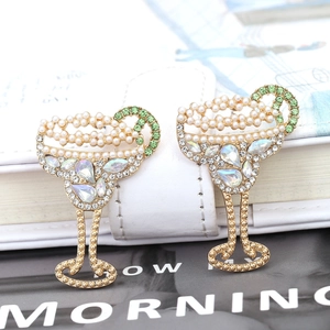 Vintage gold cocktail glass earrings with pearls and crystals on white leather