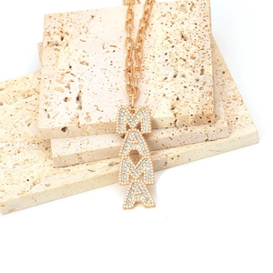 Detailed view of gold MAMA letter pendant with inlaid pearls on oval link chain
