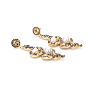 Vintage gold snake drop earrings featuring grey rhinestones and elegant white pearls