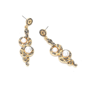 Retro gold snake drop earrings with black rhinestones and white pearls on white surface