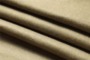 Detailed close-up of golden brown cashmere-like scarf showing soft twill texture and fabric fibers