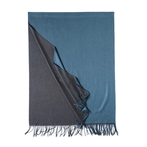 Detail view of double-sided cashmere-like scarf with blue and grey tones and soft tassels