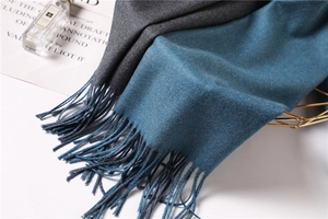 Detailed macro view of dual-color pashmina scarf with elegant long fringes and soft texture